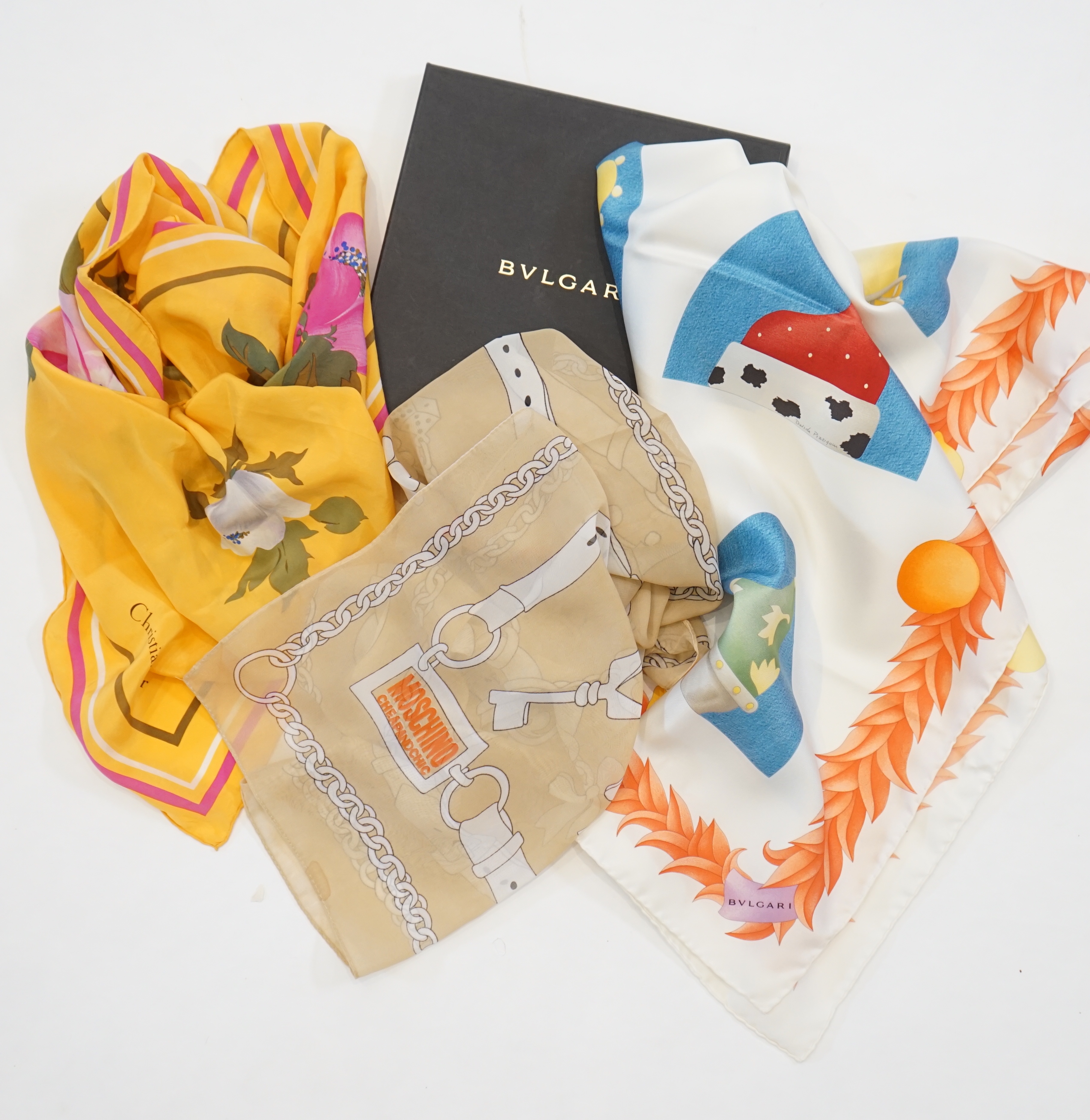 A Bvlgari by Davide Pizzigoni silk scarf, a yellow floral Christian Dior silk scarf and a Moschino Cheap and Chic chiffon scarf
